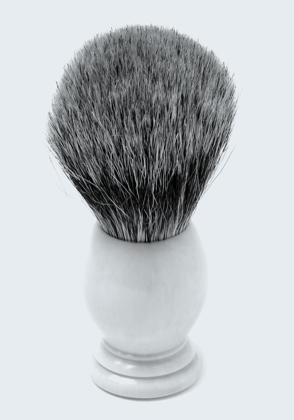 A badger-hair shaving brush with a pale handle