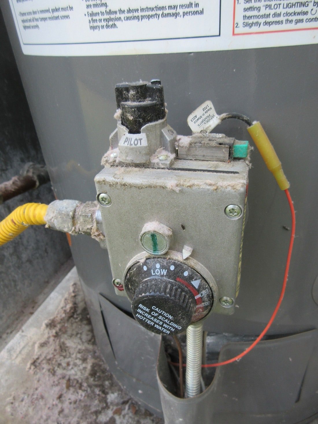 The gas control valve and temperature dial on a water heater